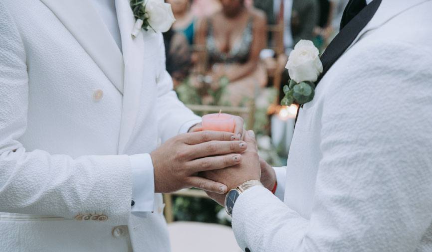 Pareja de esposos cogiéndose las manos y sosteniendo una vela